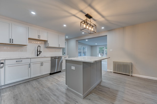 kitchen with a sink, light wood-type flooring, decorative backsplash, dishwasher, and radiator