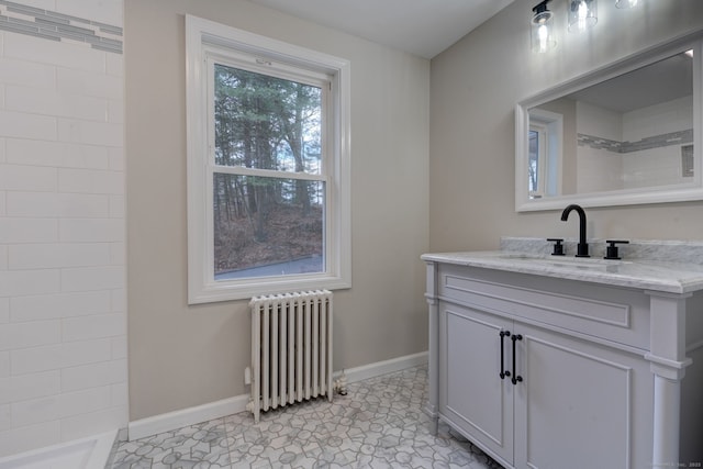 bathroom featuring radiator heating unit, baseboards, and vanity