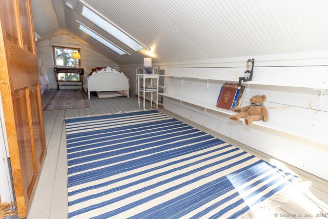 unfurnished bedroom featuring vaulted ceiling with skylight