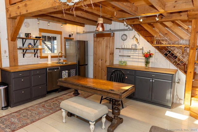 kitchen featuring open shelves, stainless steel appliances, wooden counters, and beam ceiling