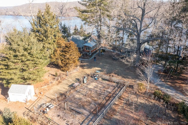 birds eye view of property with a water view