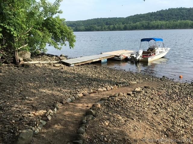 view of dock with a water view and a view of trees