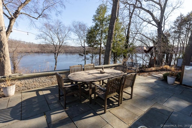 view of patio with outdoor dining space and a water view