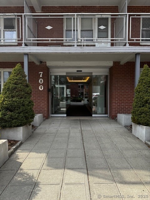 700 Summer St, Stamford, CT 09605 - doorway to property with brick siding and a balcony