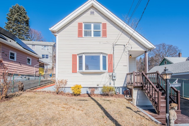 view of front of house with fence and a front lawn