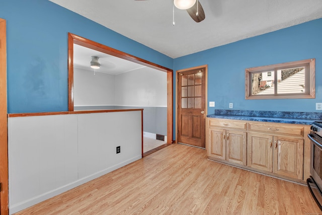 interior space featuring dark countertops, visible vents, ceiling fan, and light wood finished floors