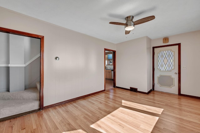 unfurnished room featuring baseboards, ceiling fan, visible vents, and wood finished floors