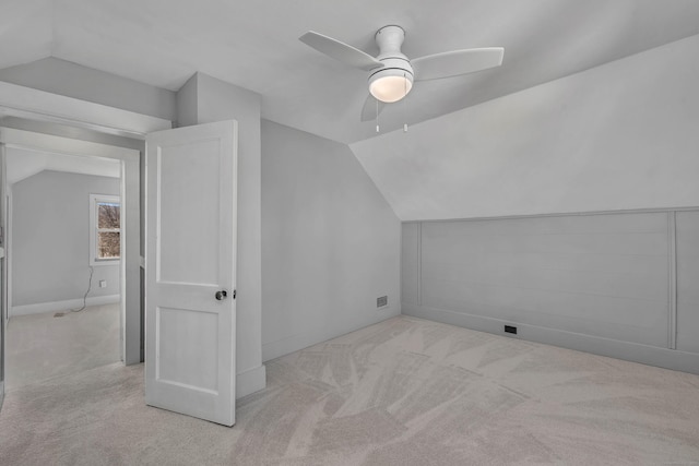 bonus room with carpet floors, ceiling fan, and vaulted ceiling