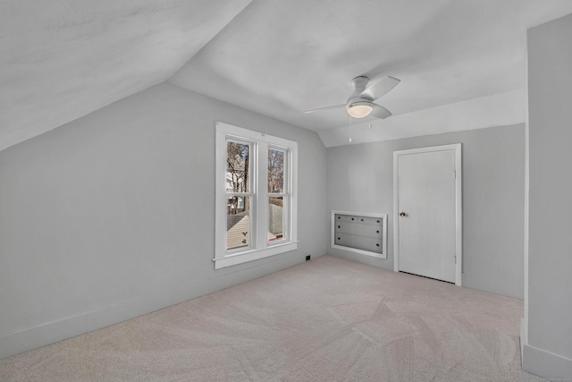 additional living space with vaulted ceiling, carpet flooring, and a ceiling fan