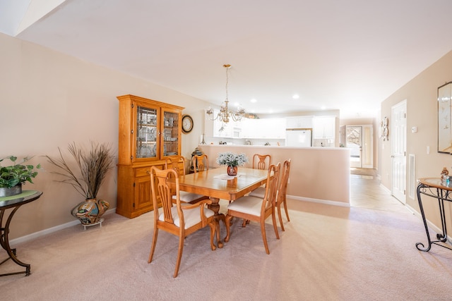 dining space with recessed lighting, baseboards, a chandelier, and light colored carpet