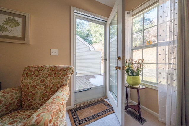 entryway featuring baseboards, visible vents, and a healthy amount of sunlight