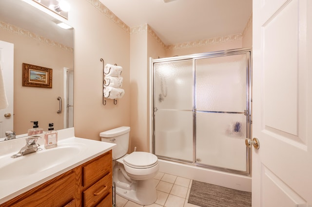 full bath featuring a stall shower, vanity, toilet, and tile patterned floors