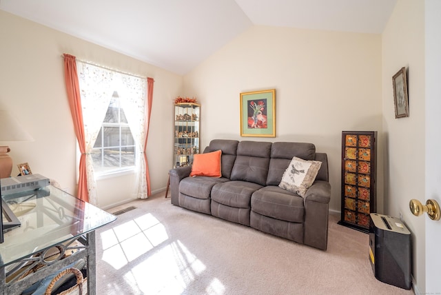 living area with carpet floors, lofted ceiling, and visible vents