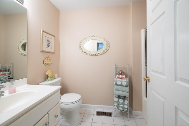 bathroom featuring visible vents, toilet, vanity, baseboards, and tile patterned floors