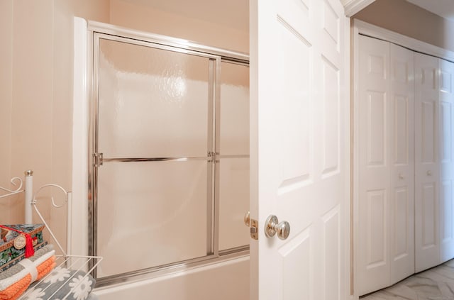 full bath featuring shower / bath combination with glass door