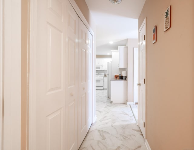 hallway featuring baseboards, marble finish floor, and recessed lighting