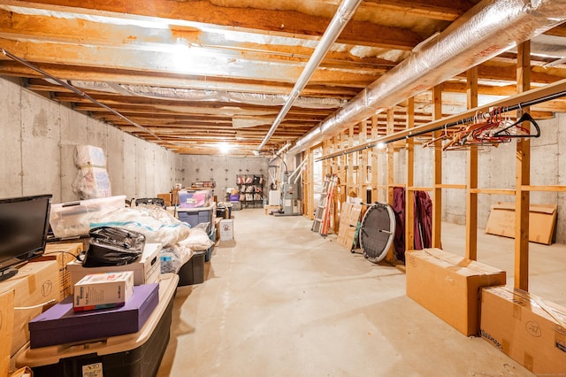 unfinished basement featuring heating unit