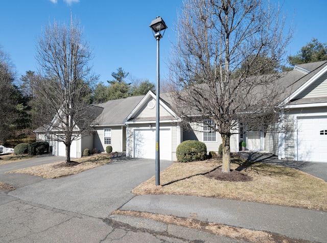 ranch-style home featuring a garage and driveway