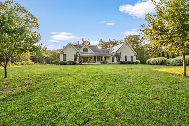 view of front of property with a chimney and a front yard