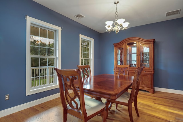 dining room featuring a wealth of natural light, visible vents, light wood-style flooring, and baseboards