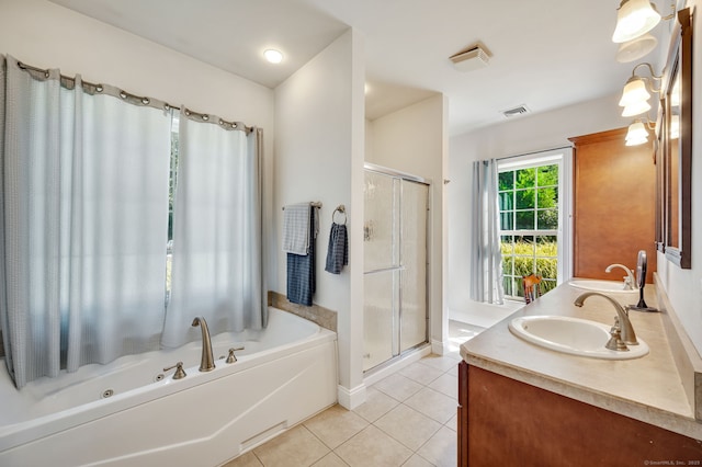 full bathroom with double vanity, tile patterned floors, a garden tub, a shower stall, and a sink