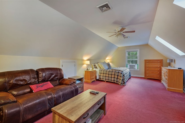 bedroom featuring ceiling fan, dark colored carpet, lofted ceiling with skylight, and visible vents