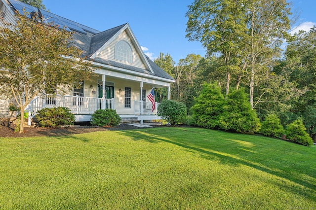 view of front of house with a porch, a front lawn, and a shingled roof