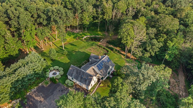 birds eye view of property with a view of trees