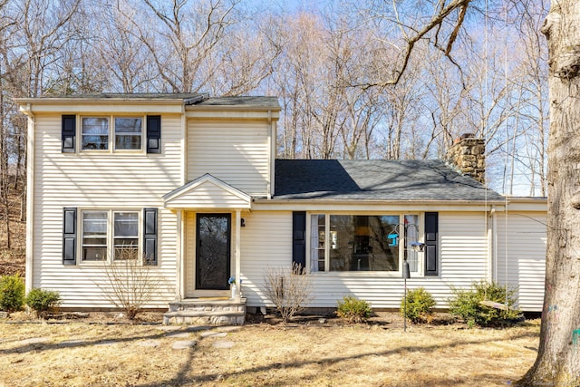 traditional-style home with entry steps and a chimney