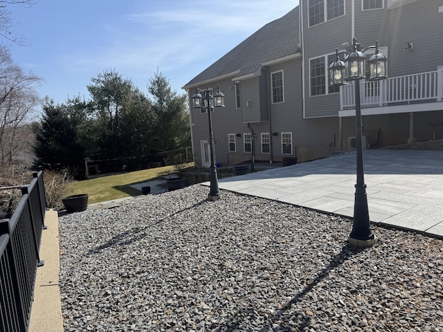 rear view of house with a patio area and fence