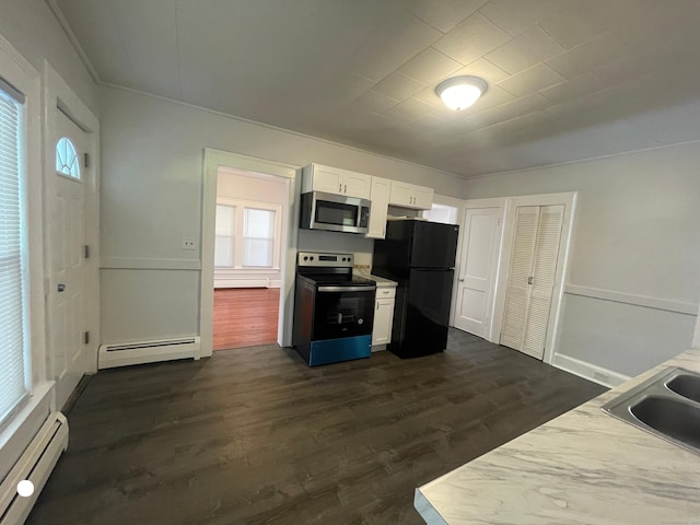 kitchen featuring a baseboard radiator, stainless steel appliances, and dark wood finished floors