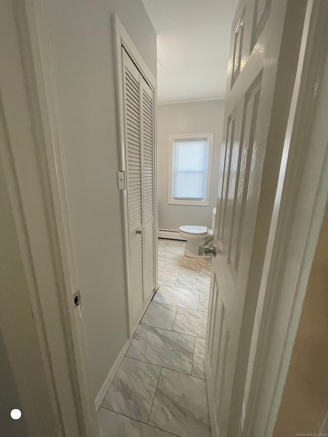 hallway with baseboards, marble finish floor, and crown molding