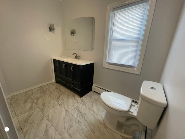 half bathroom featuring marble finish floor, toilet, vanity, plenty of natural light, and baseboards