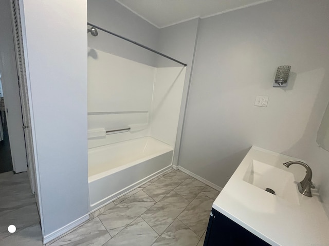 bathroom featuring marble finish floor, shower / bath combination, vanity, and baseboards