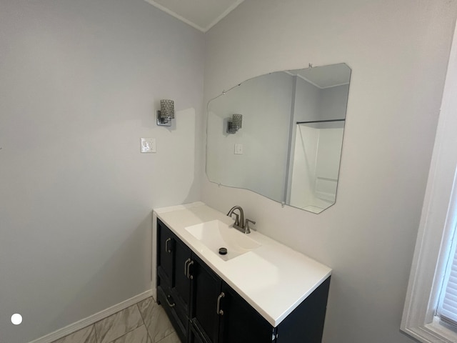 bathroom featuring marble finish floor, baseboards, and vanity