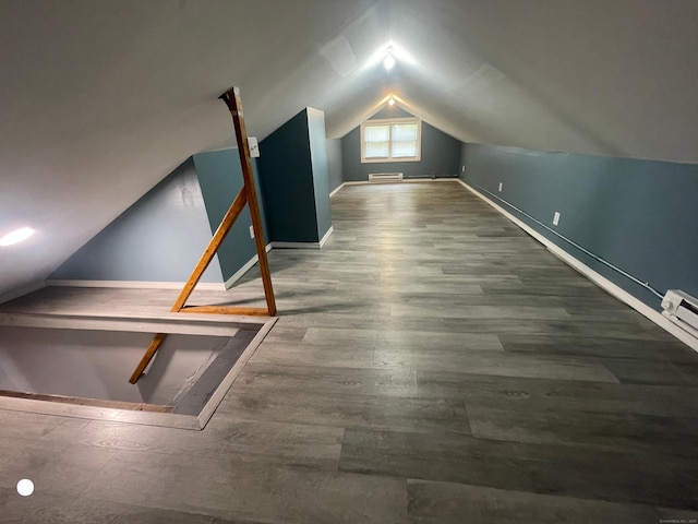 bonus room featuring lofted ceiling and wood finished floors