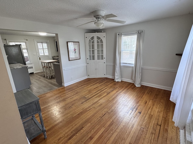 interior space featuring radiator, plenty of natural light, and wood-type flooring