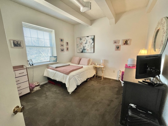 bedroom featuring baseboards, dark colored carpet, and beam ceiling