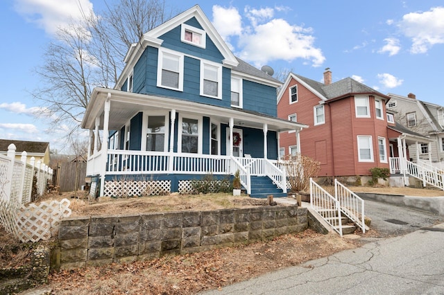 view of front of property with covered porch and fence