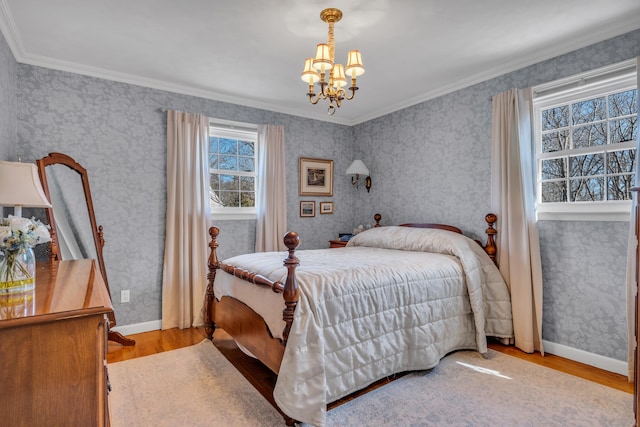 bedroom featuring a notable chandelier, wallpapered walls, baseboards, and wood finished floors