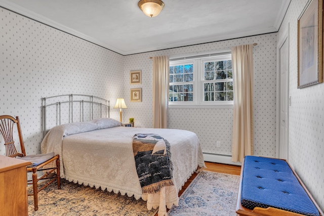 bedroom featuring baseboard heating, ornamental molding, wallpapered walls, and wood finished floors