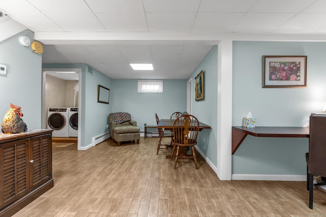 sitting room with visible vents, a baseboard heating unit, separate washer and dryer, light wood finished floors, and baseboard heating