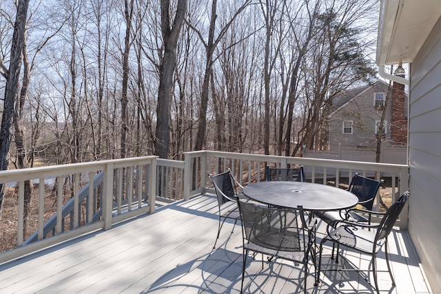 wooden terrace featuring outdoor dining area