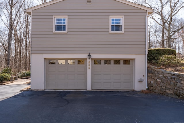 garage with aphalt driveway