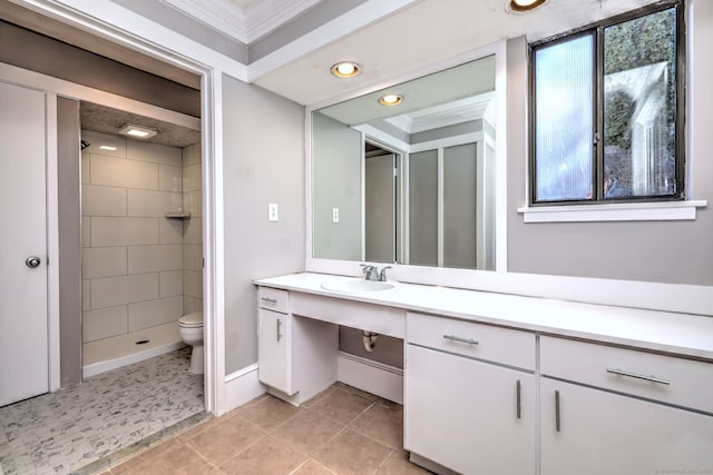 bathroom featuring tile patterned flooring, a healthy amount of sunlight, vanity, and toilet