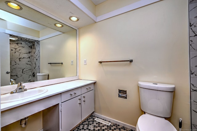 bathroom with visible vents, toilet, vanity, tile patterned flooring, and baseboards
