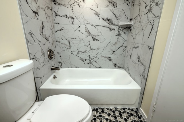 bathroom with toilet and shower / bath combination