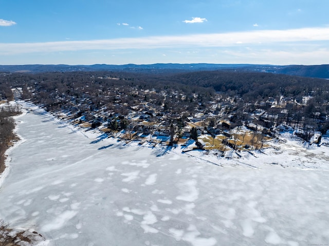 snowy aerial view featuring a mountain view