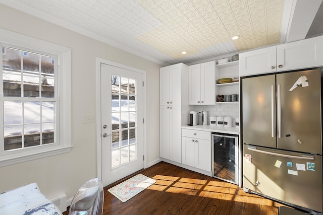 kitchen featuring open shelves, backsplash, freestanding refrigerator, wood finished floors, and beverage cooler