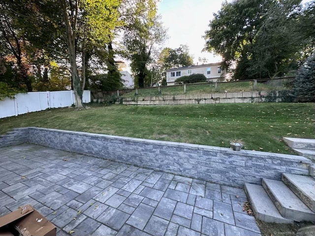 view of home's community featuring a yard, a patio area, and a fenced backyard